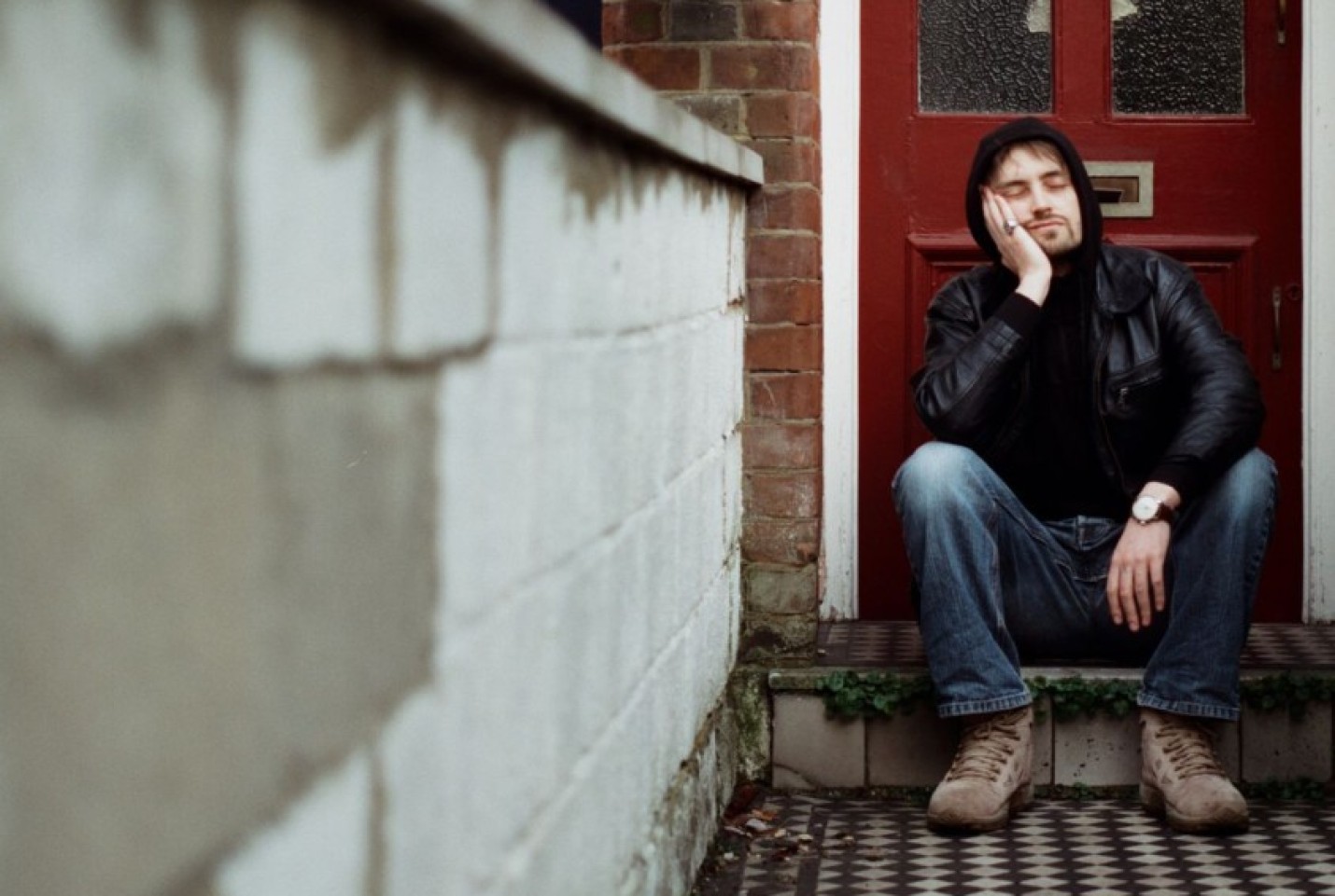 CALLINSICK sitting at a door with his head in their hands.